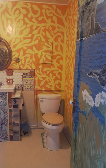 Standard size toilet with tiled walls.